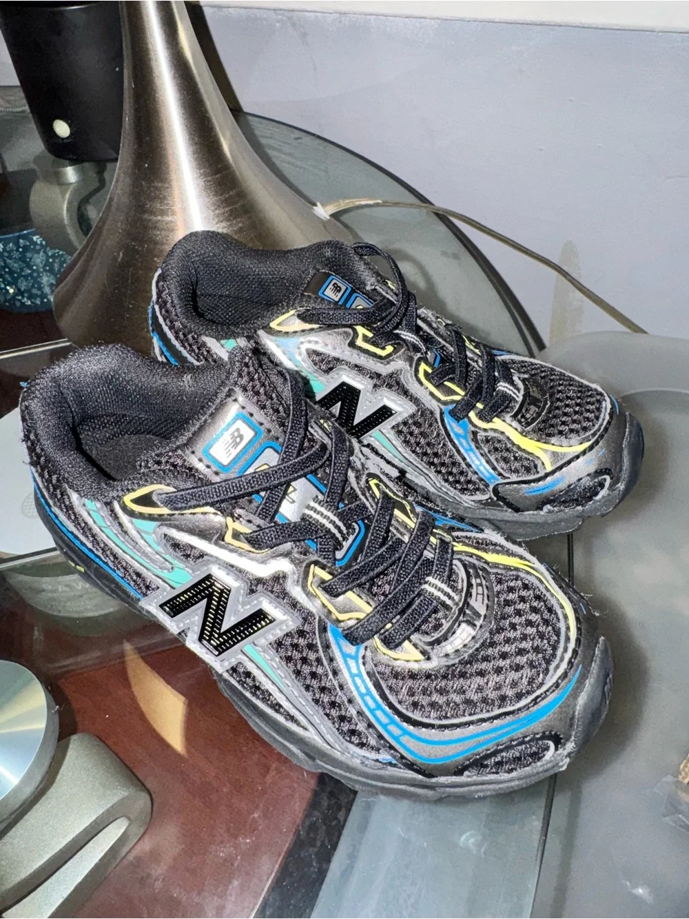 New Balance Kids Black with Blue & Silver Accent Sneakers